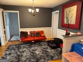 sitting room featuring light hardwood / wood-style flooring and a chandelier