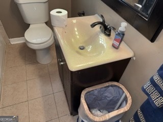 bathroom featuring toilet, vanity, and tile patterned floors