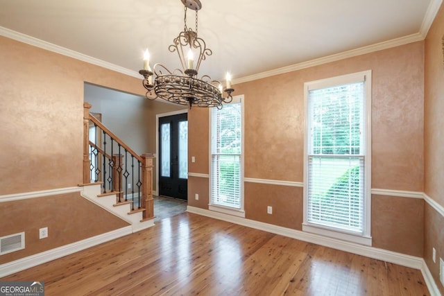 2505 Westchester Way, Conyers, GA 30013 - unfurnished dining area with wood finished floors, a chandelier, baseboards, stairway, and ornamental molding