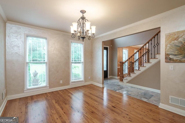 unfurnished dining area featuring hardwood / wood-style floors, a chandelier, and ornamental molding