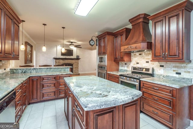 kitchen with custom exhaust hood, hanging light fixtures, ceiling fan, a kitchen island, and stainless steel appliances