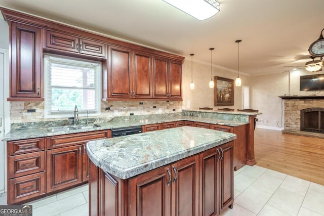 2505 Westchester Way, Conyers, GA 30013 - kitchen with a peninsula, open floor plan, a ceiling fan, light stone counters, and hanging light fixtures