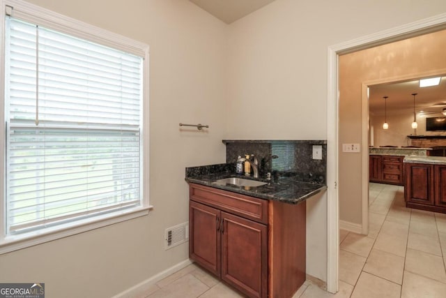 2505 Westchester Way, Conyers, GA 30013 - bar area with a sink, light tile patterned floors, backsplash, and baseboards