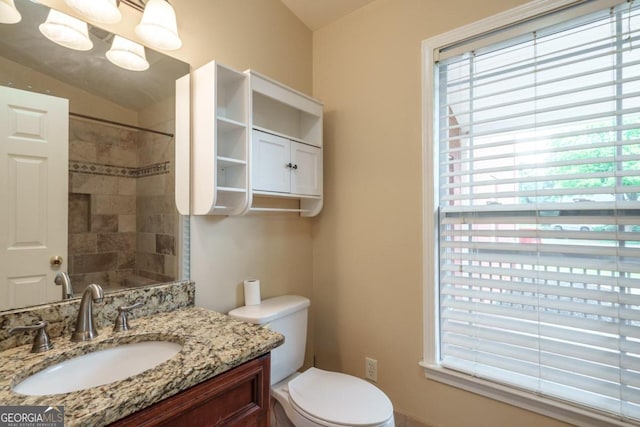 2505 Westchester Way, Conyers, GA 30013 - bathroom featuring healthy amount of natural light, vanity, toilet, a tile shower, and lofted ceiling