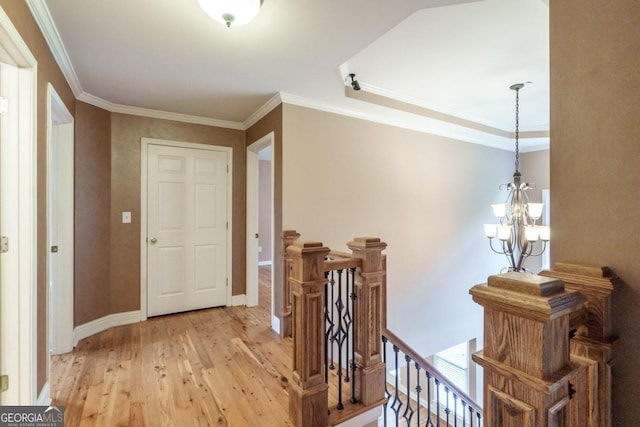 2505 Westchester Way, Conyers, GA 30013 - hallway featuring an upstairs landing, light wood-type flooring, a chandelier, crown molding, and baseboards