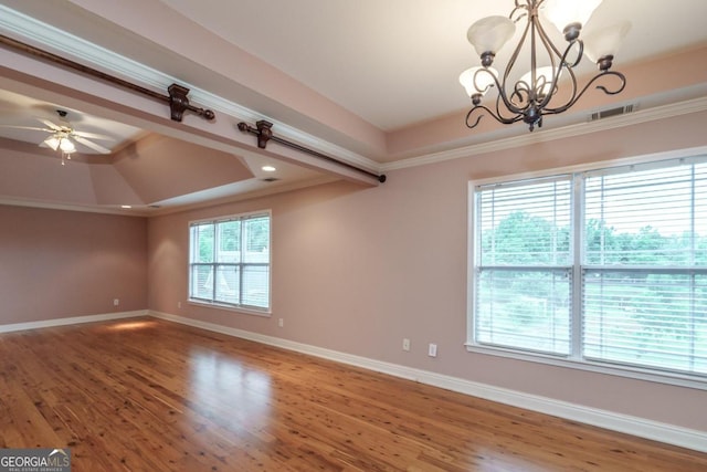 spare room featuring crown molding, plenty of natural light, ceiling fan with notable chandelier, and hardwood / wood-style flooring