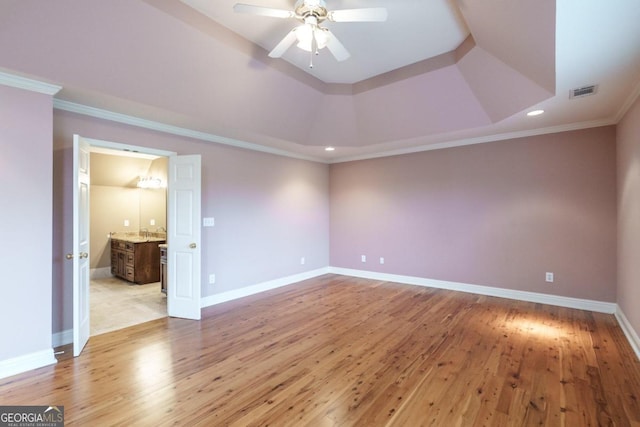 unfurnished bedroom with ceiling fan, light hardwood / wood-style floors, crown molding, and ensuite bath