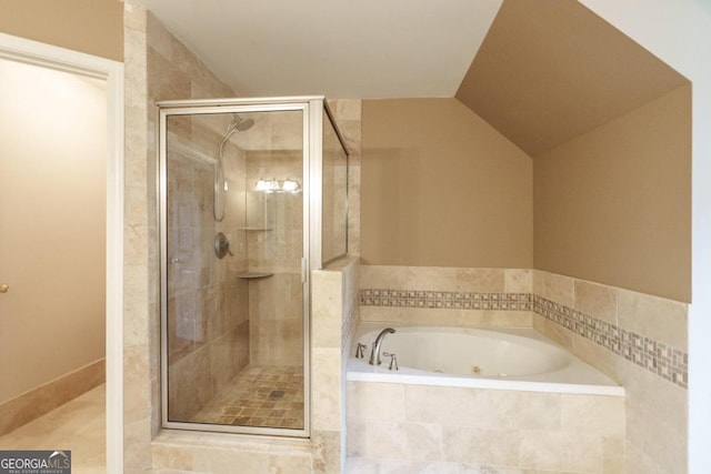 bathroom with tile patterned flooring, independent shower and bath, and lofted ceiling