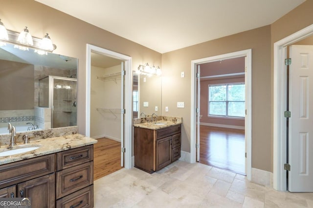 bathroom with hardwood / wood-style flooring, vanity, and independent shower and bath