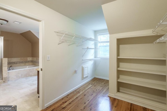 spacious closet featuring light hardwood / wood-style flooring