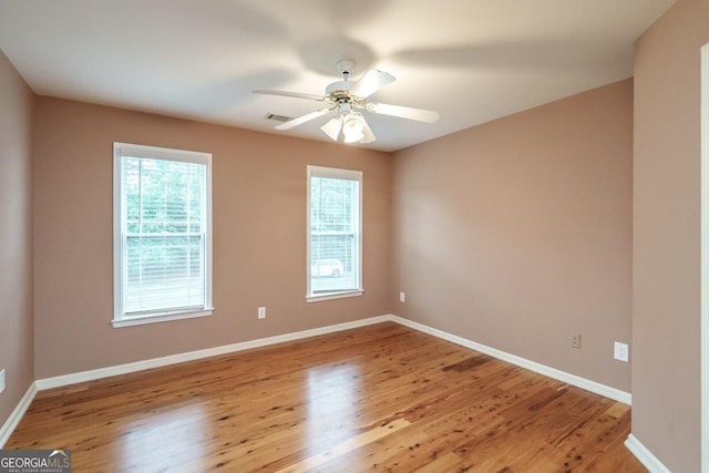 spare room featuring ceiling fan and light hardwood / wood-style floors