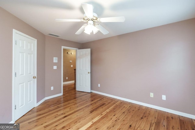 unfurnished bedroom with ceiling fan and light hardwood / wood-style flooring