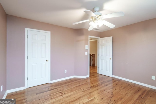 unfurnished bedroom with ceiling fan and light hardwood / wood-style floors