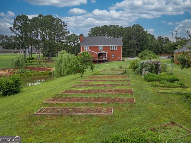 2505 Westchester Way, Conyers, GA 30013 - view of green lawn featuring a garden and a deck with water view