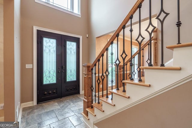2505 Westchester Way, Conyers, GA 30013 - foyer with stairs, a towering ceiling, french doors, baseboards, and stone finish floors