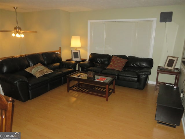 living room with light wood-type flooring and ceiling fan