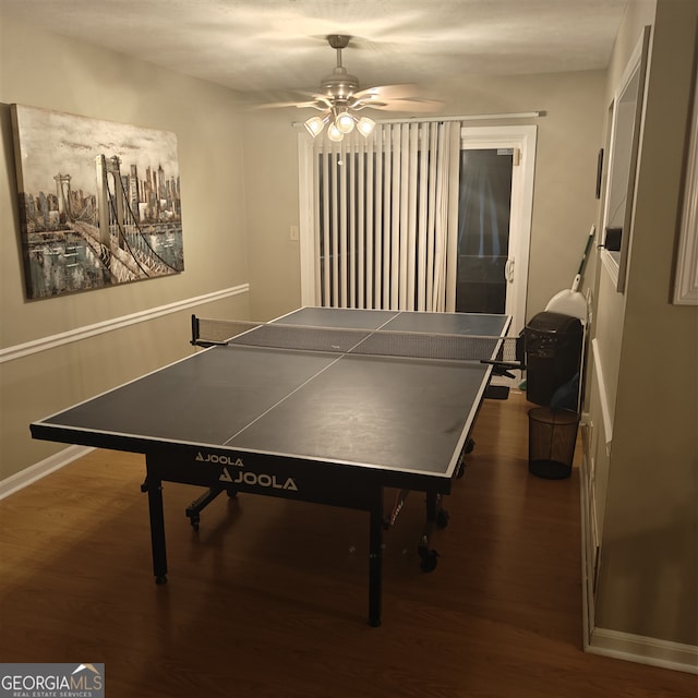 recreation room featuring dark hardwood / wood-style floors and ceiling fan