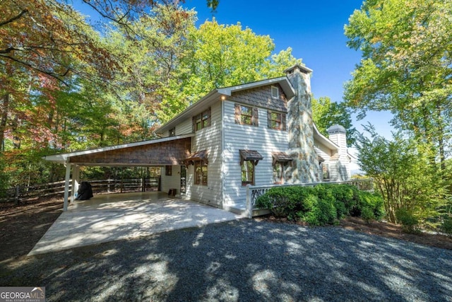 view of side of home featuring a carport