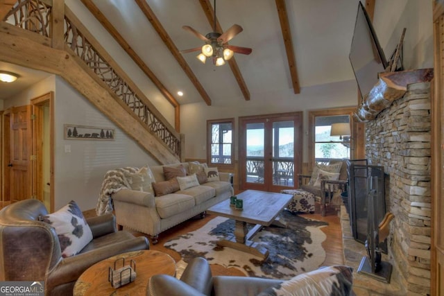 living room with ceiling fan, french doors, high vaulted ceiling, beamed ceiling, and light wood-type flooring