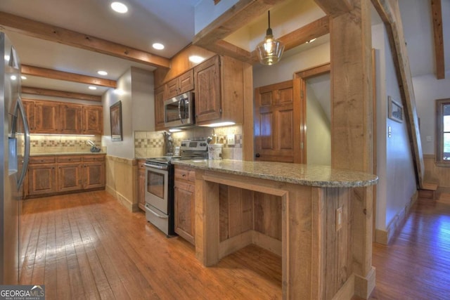 kitchen featuring backsplash, light wood-type flooring, appliances with stainless steel finishes, beam ceiling, and kitchen peninsula