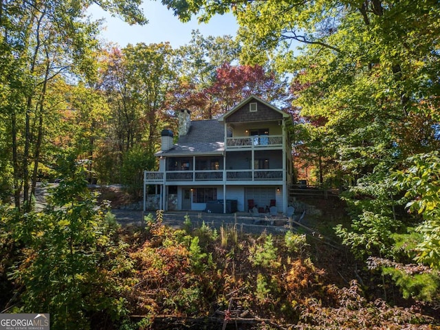 back of property featuring a balcony