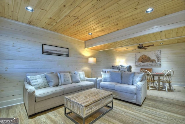 living room with wooden walls, wooden ceiling, and light wood-type flooring