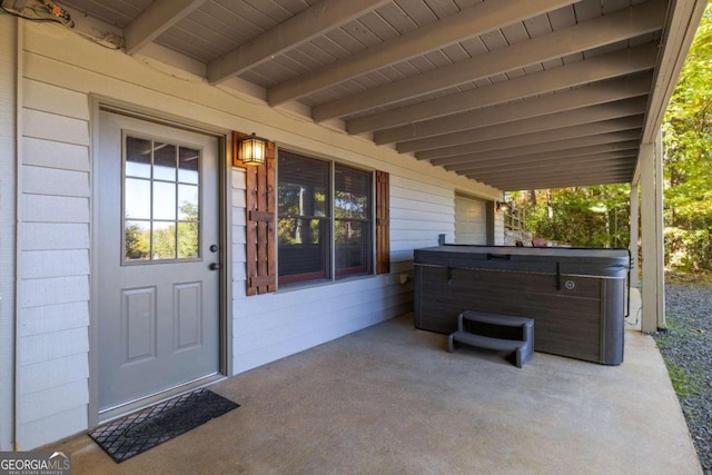 view of patio / terrace with a hot tub