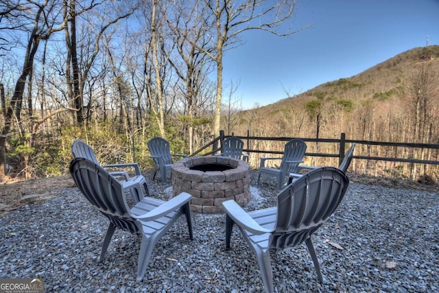 view of yard featuring a mountain view and a fire pit