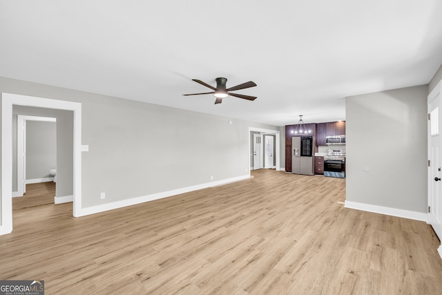 unfurnished living room featuring ceiling fan and light wood-type flooring