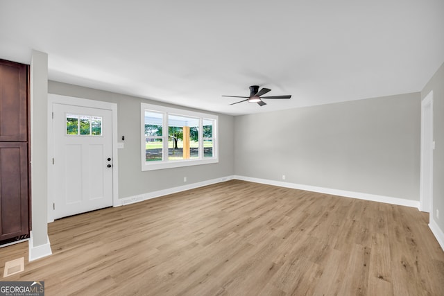 foyer entrance with ceiling fan and light wood-type flooring