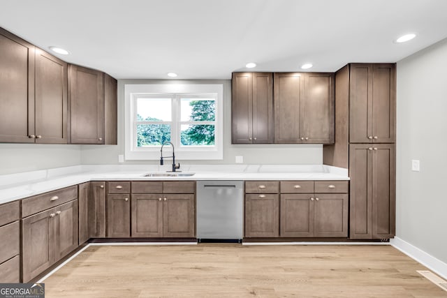 kitchen with sink, light stone counters, dark brown cabinets, dishwasher, and light hardwood / wood-style floors