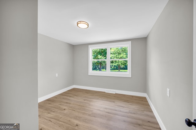 spare room featuring light hardwood / wood-style floors