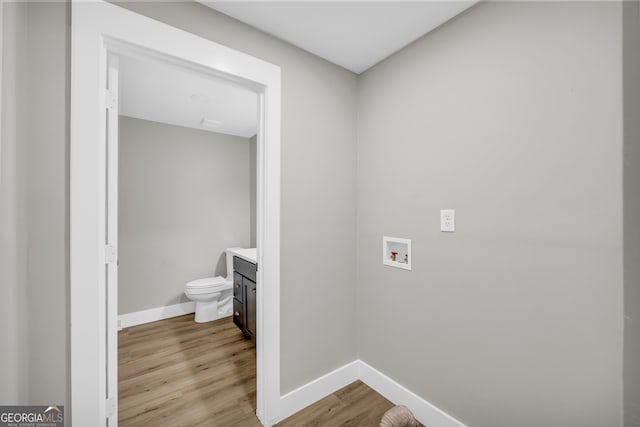 laundry area with hookup for a washing machine and light hardwood / wood-style flooring