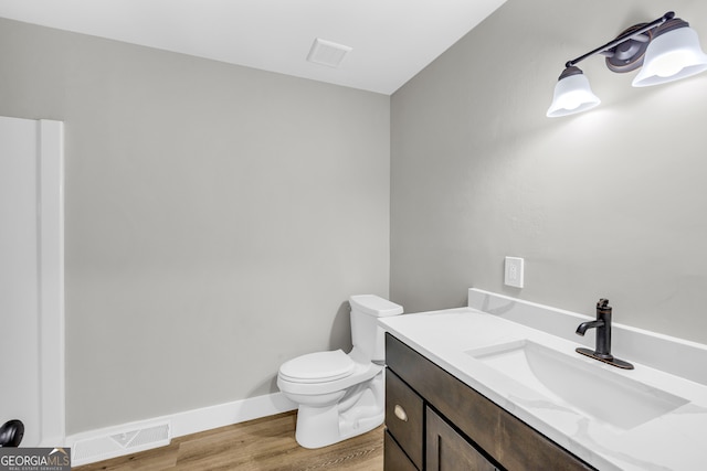 bathroom featuring vanity, toilet, and wood-type flooring