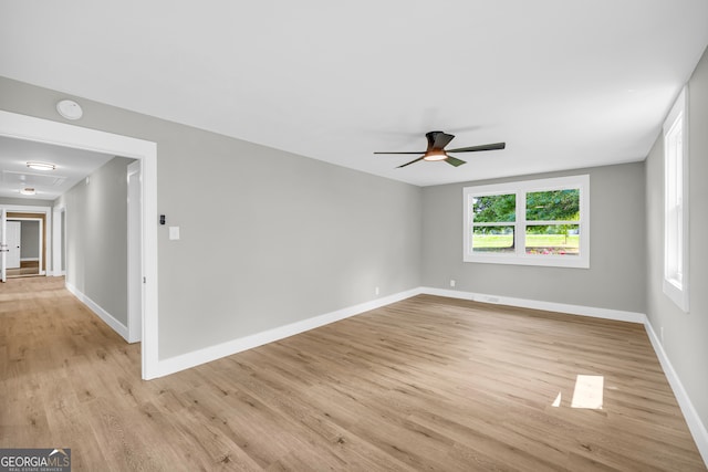 empty room featuring ceiling fan and light hardwood / wood-style flooring