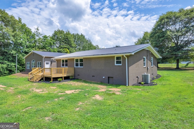 rear view of property with a wooden deck, a yard, and cooling unit