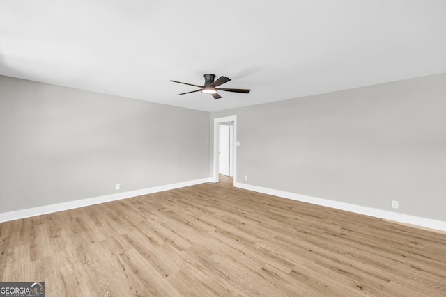 spare room featuring ceiling fan and light wood-type flooring