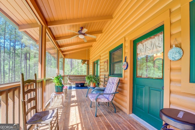 wooden deck with covered porch and ceiling fan