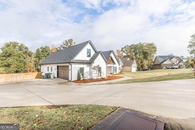 modern farmhouse style home with a garage and a front lawn