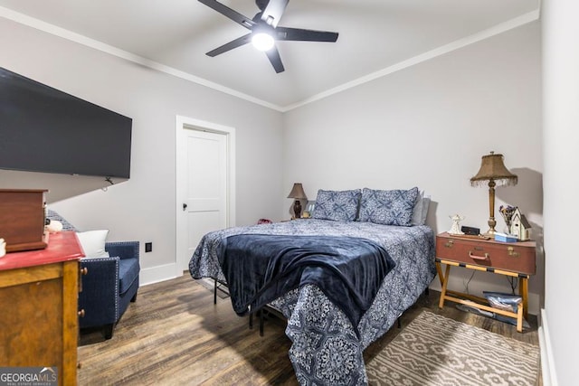 bedroom with ceiling fan, dark hardwood / wood-style flooring, and ornamental molding