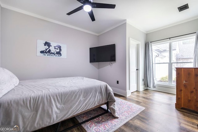 bedroom featuring ceiling fan, ornamental molding, and hardwood / wood-style flooring