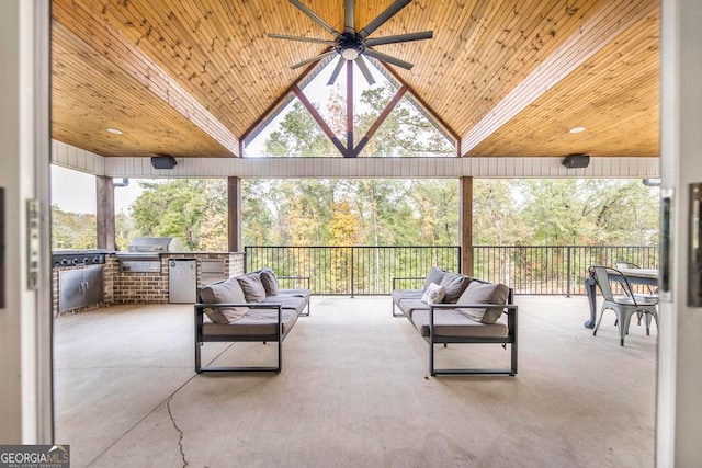 view of patio featuring outdoor lounge area, ceiling fan, exterior kitchen, and a grill