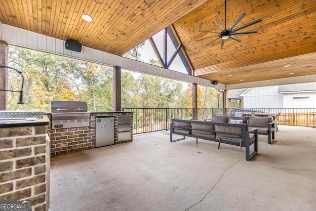 view of patio featuring grilling area, ceiling fan, outdoor lounge area, and exterior kitchen