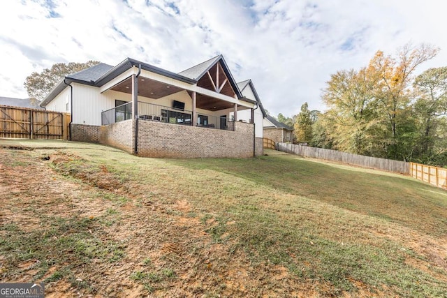 rear view of property featuring a yard