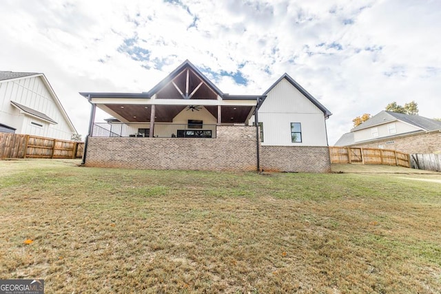 back of property with a lawn and ceiling fan