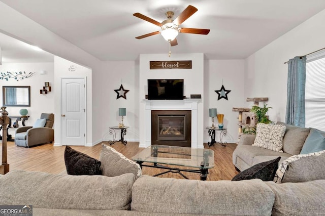 living room with ceiling fan and hardwood / wood-style flooring