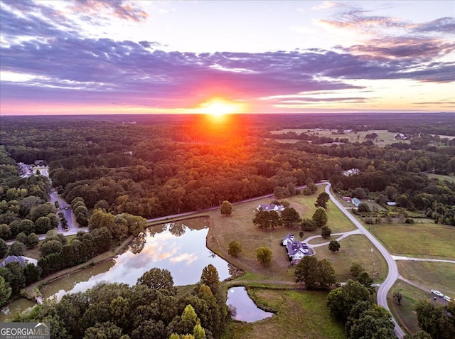 aerial view at dusk with a water view