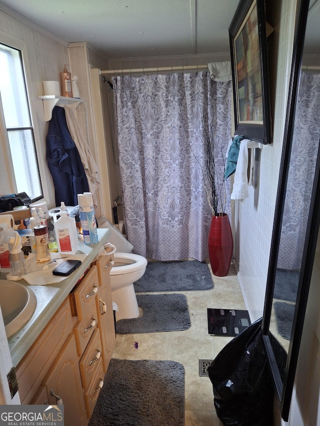 full bathroom featuring toilet, tile patterned floors, ornamental molding, and vanity