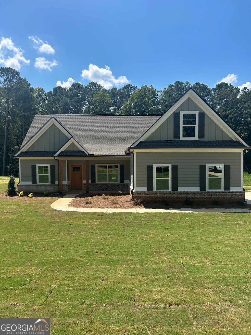 craftsman-style house with a front lawn