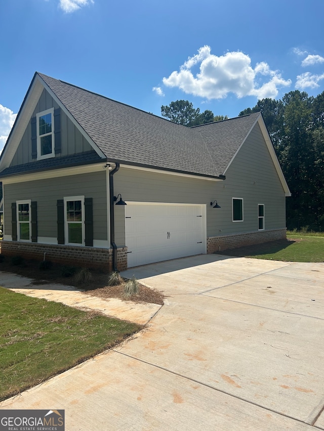 view of side of home featuring a garage